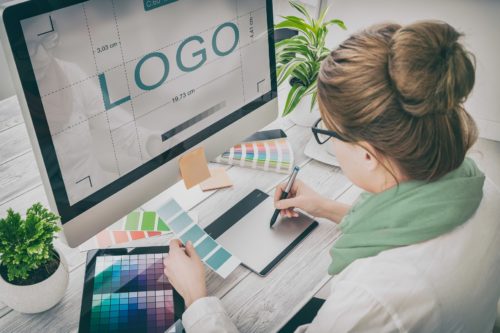 The woman designs a logo on the PC